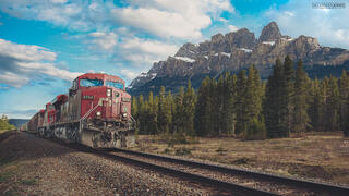 CN freight train going past castle mountain in Banff National Park in Canadian Rocky Mountains in Canada