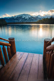 Sun setting over mountain lake in jasper national park in canadian rocky mountains