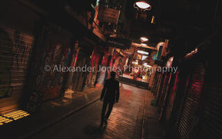 a man walking down degraves street in melbourne australia silhouetted by the lights