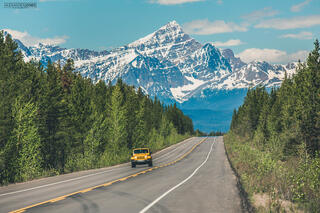 car driving on mountain icefields parkway road during spring in canadian rocky mountains 