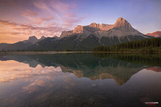 mountain reflection on mirror lake at quarry lake canmore