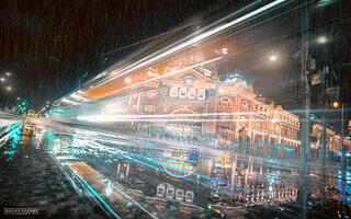 a tram long exposure passing flinders street station on a rainy night in melbourne australia