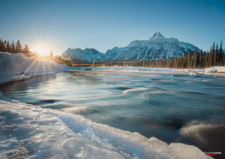 sun rising over mountains in Jasper National Park in Canadian Rocky Mountains