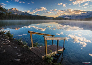 mountain mirror reflection on lake during sunrise in Jasper National Park in Canadian Rocky Mountains