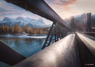 canmore engine bridge during sunset in canmore alberta sun setting over snow capped mountains
