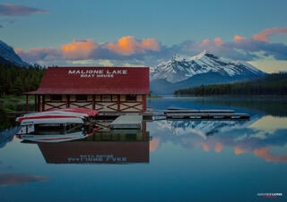 Sun rising over Maligne Lake mountains and boathouse in Jasper National Park in Canadian Rocky Mountains
