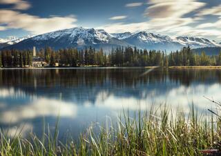 snow capped mountains with mirror reflection in jasper national park in canadian rocky mountains 
