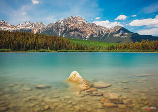 bright summer lake with snow capped mountains in canadian rocky mountains in jasper national park