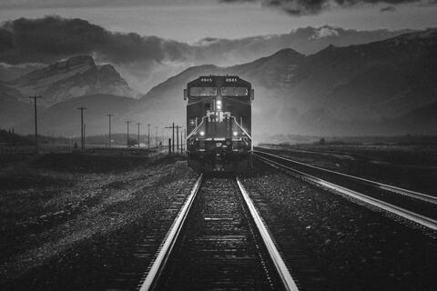 black and white train in mountains 