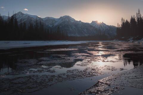 Ice flowing down river during sunrise in Banff National Park