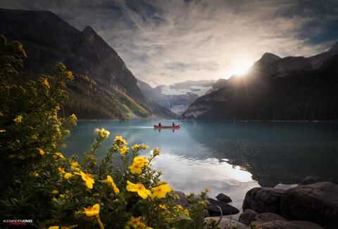 a canoe floating on lake louise during sunset