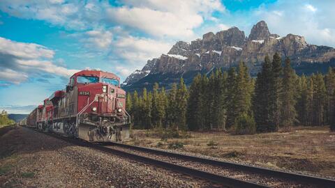 CN freight train going past castle mountain in Banff National Park in Canadian Rocky Mountains in Canada