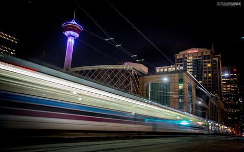 Long exposure of calgary metro train with calgary tower in background in the city of calgary canada
