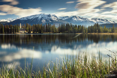 snow capped mountains with mirror reflection in jasper national park in canadian rocky mountains 