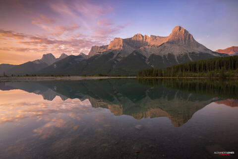 mountain reflection on mirror lake at quarry lake canmore