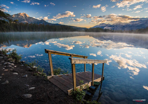 mountain mirror reflection on lake during sunrise in Jasper National Park in Canadian Rocky Mountains