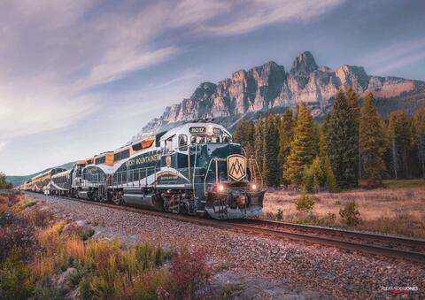 the rocky mountaineer going past castle mountain in banff national park