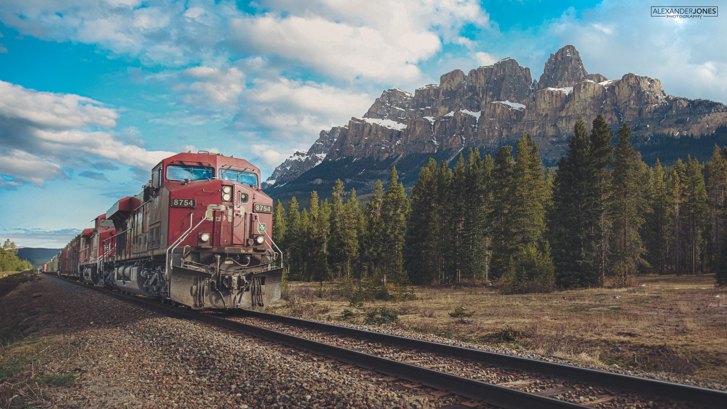 Castle Mountain Express Banff CN freight train going past castle mountain in Banff National Park in Canadian Rocky Mountains in Canada