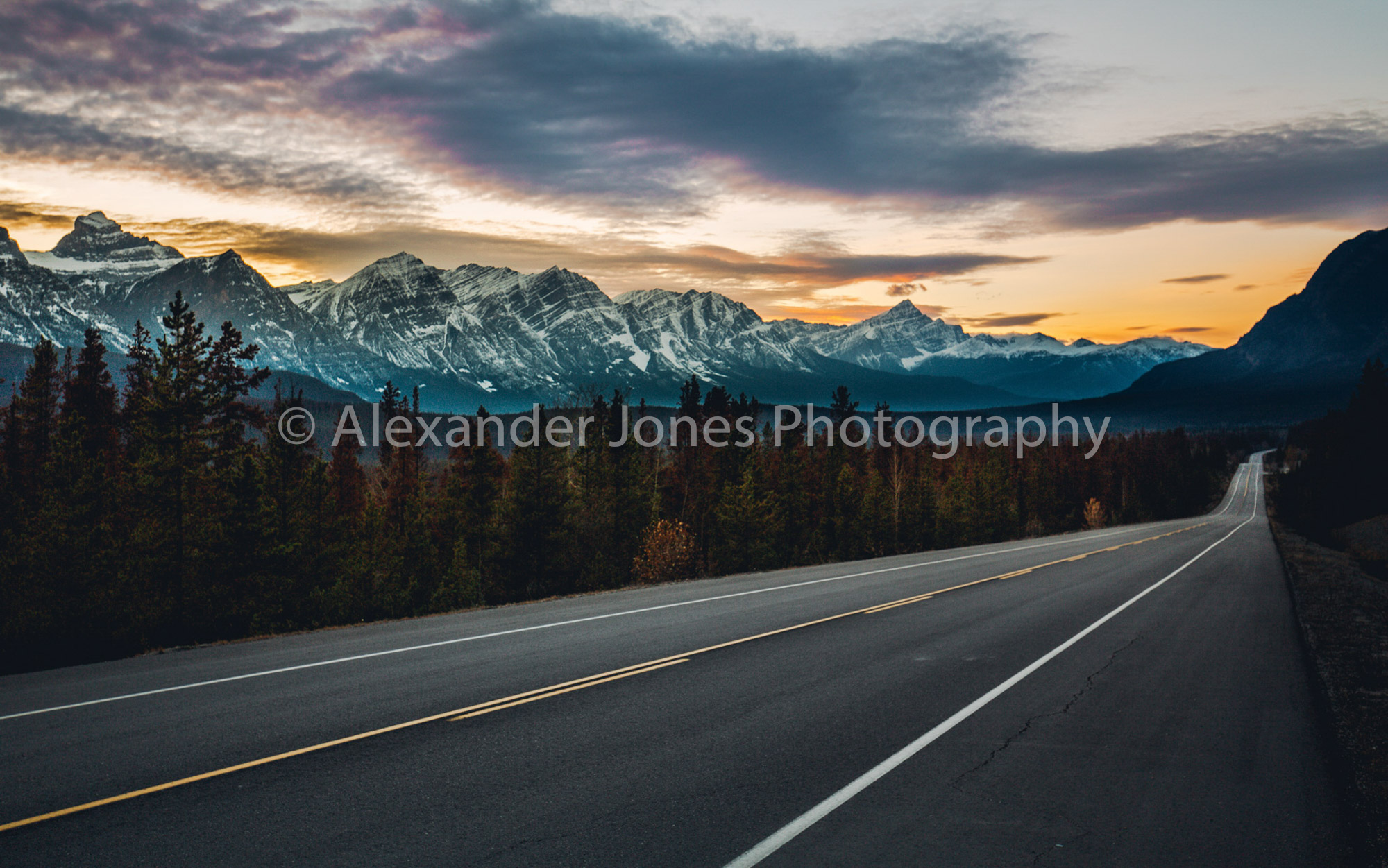 sun setting over the icefields parkway road in jasper national park in the canadian rocky mountains