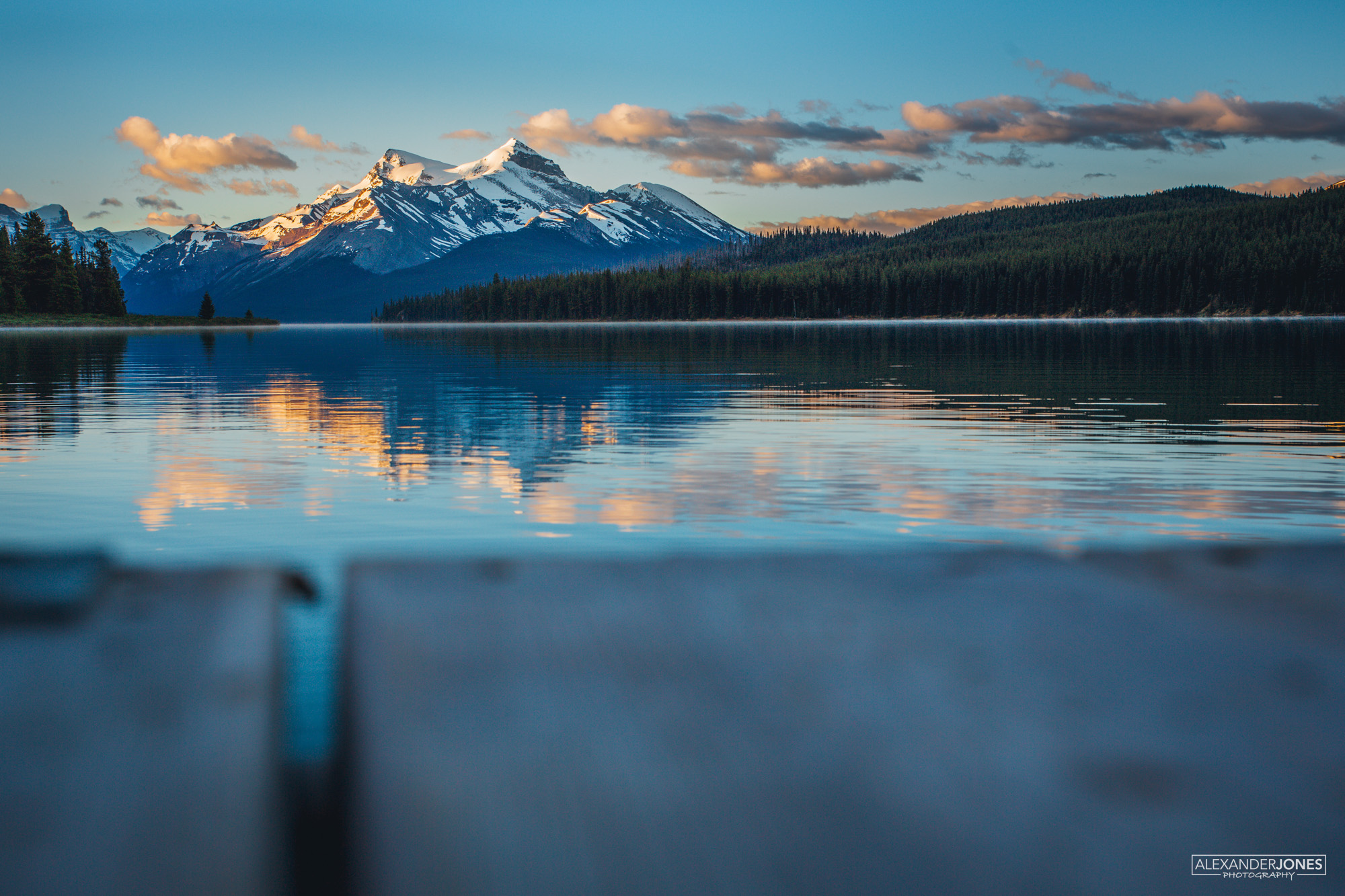 Sunrise over mountain lake at Maligne Lake in Jasper National Park in the Canadian Rocky Mountains