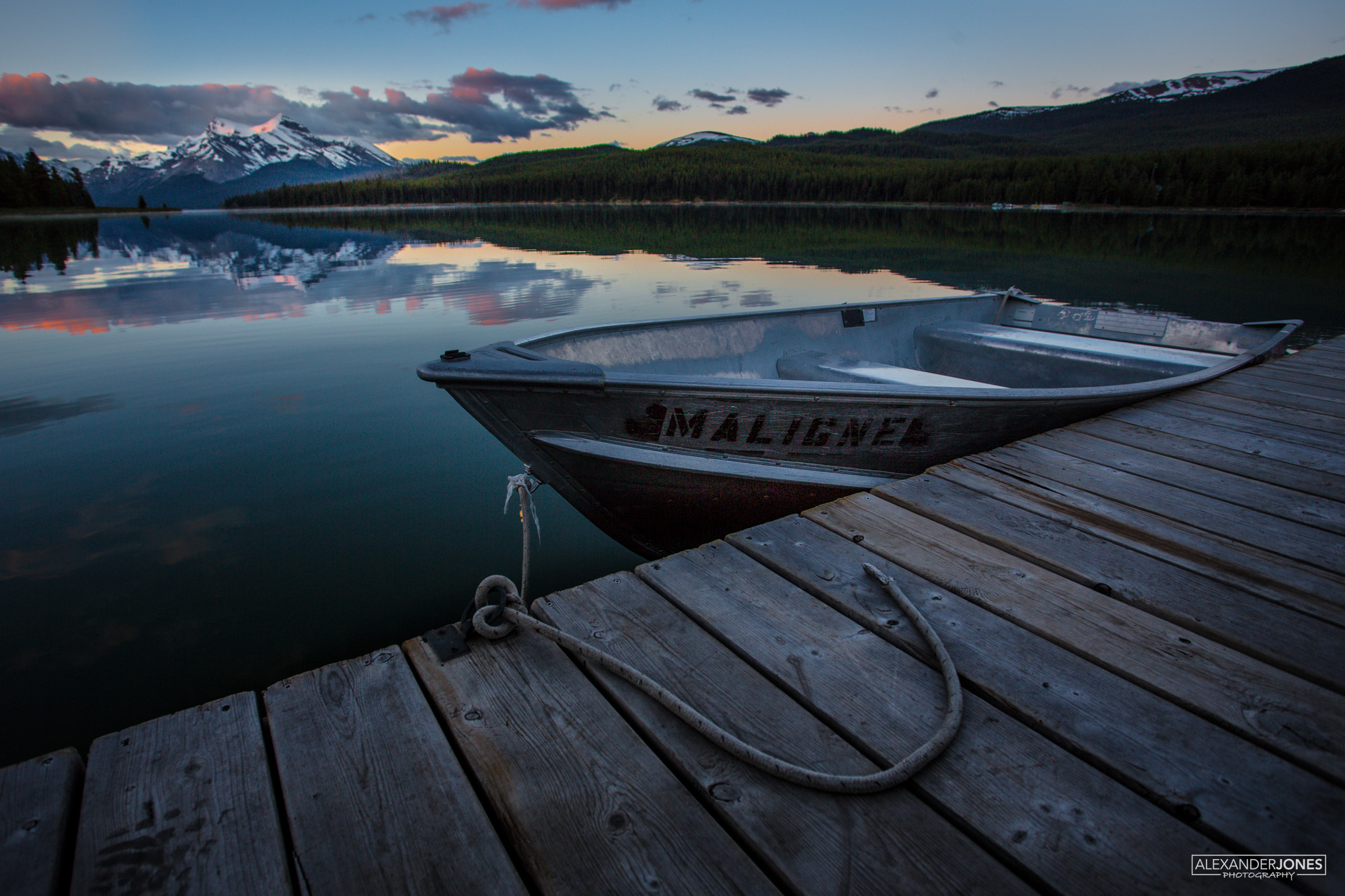 Boat Show Jasper Boat sitting idle in dock during a mountain sunrise at Maligne Lake in Jasper National Park in the Canadian Rocky Mountains