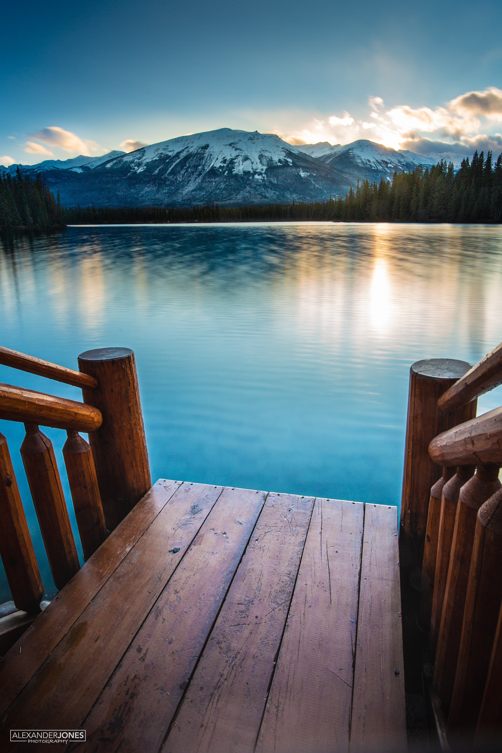 Last Glimmer Jasper Sun setting over mountain lake in jasper national park in canadian rocky mountains