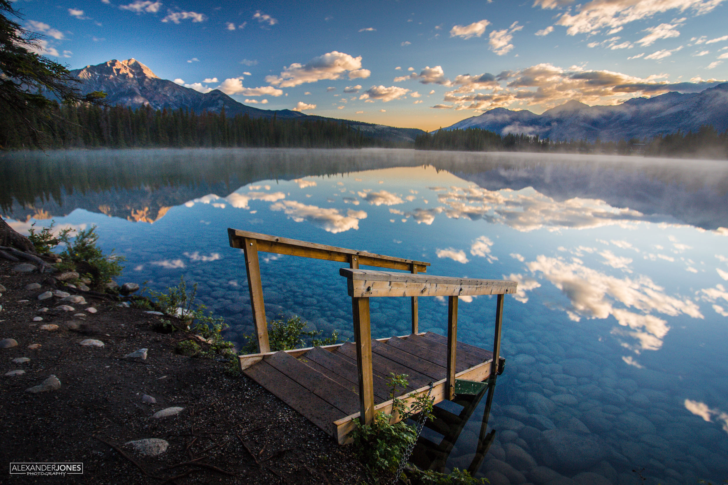 mountain mirror reflection on lake during sunrise in Jasper National Park in Canadian Rocky Mountains