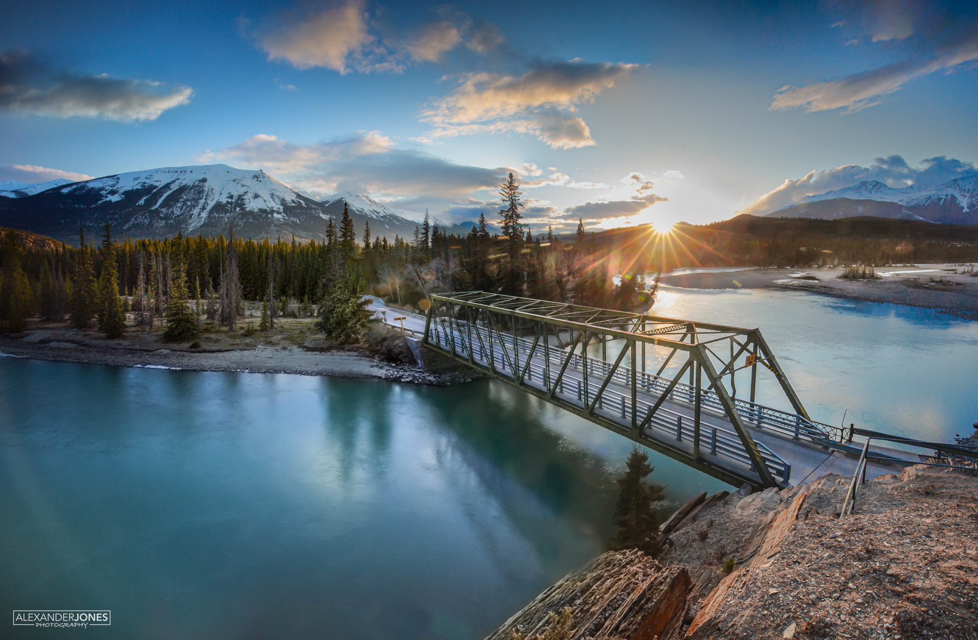 Old Fort Point Sun setting over athabasca river with sun shining on Whistler's Mountain in Jasper National Park Canada
