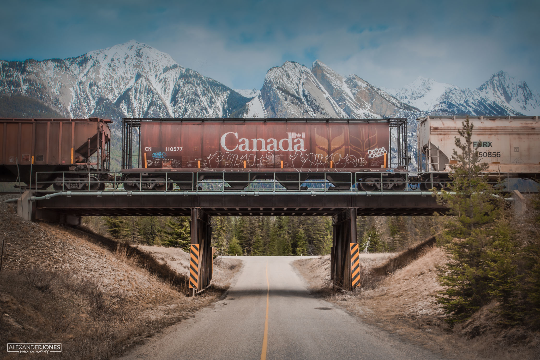 Canadian freight train with mountains in the background in the canadian rocky mountains in jasper national park