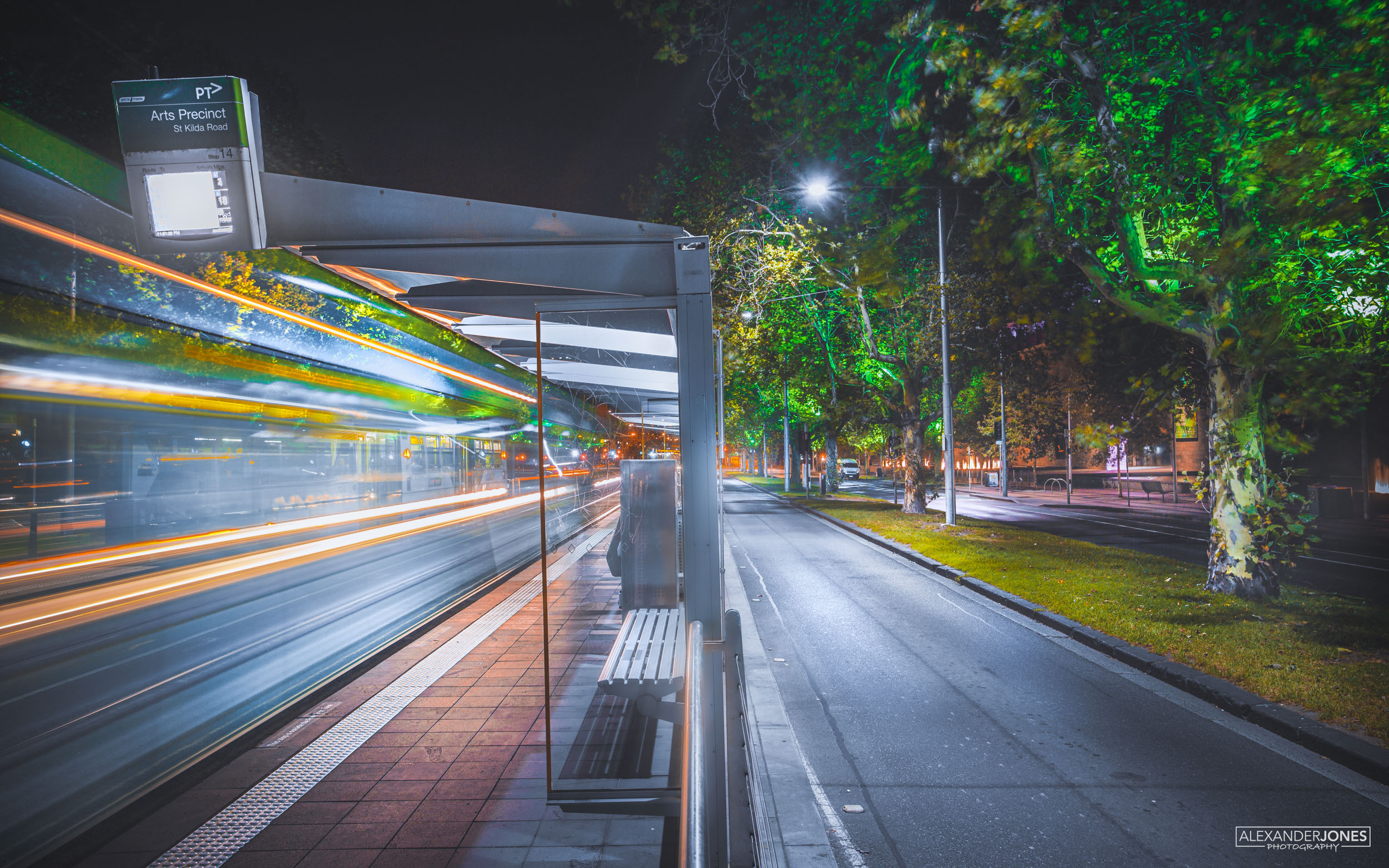 A Melbourne Metro tram in long exposure with vivid futuristic colors pulling out of a station in Melbourne, Australia