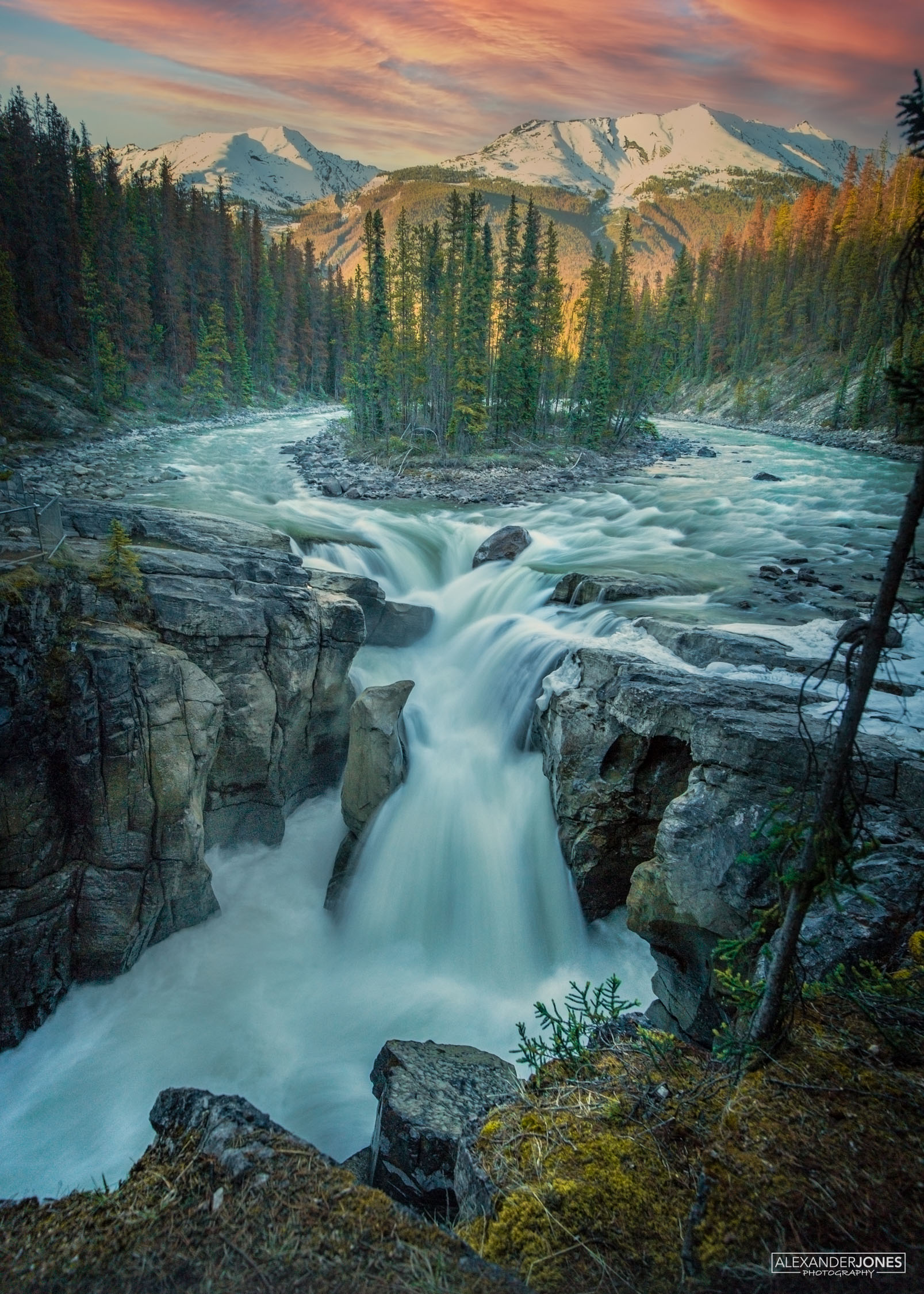Sunwapta Falls Magic Jasper Sunwapta Falls in Jasper national park during sunset on a summer evening. The Athabasca River forking around Sunwapta Island and down into the falls