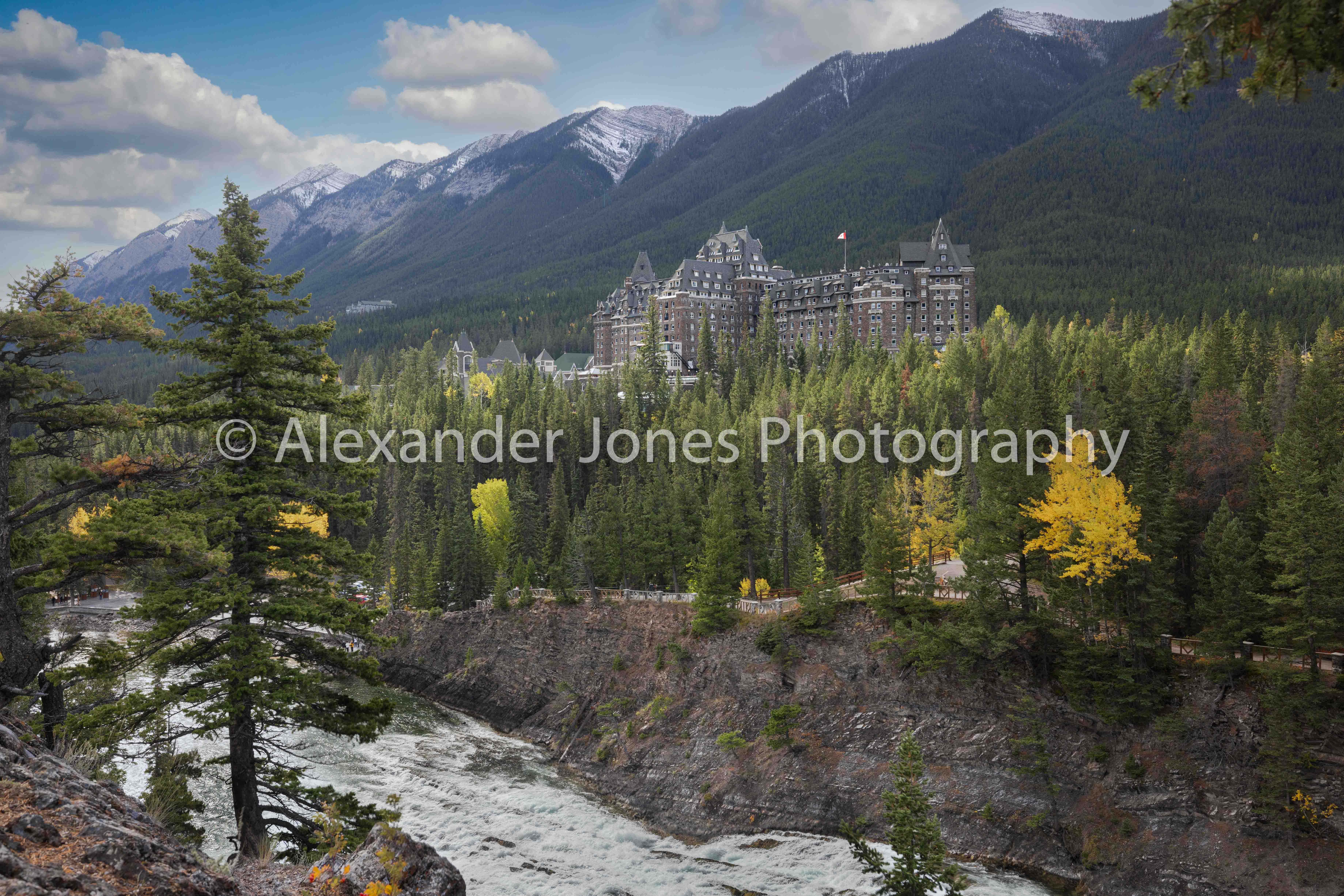 Surprise Corner & the Banff Springs Hotel quarry lake in fall in canmore with mount grassi providing a clear reflection on the lake